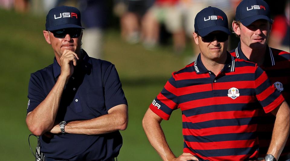 Team USA captain Davis Love III, Zach Johnson of the United States, Brandt Snedeker of the United States and Jimmy Walker of the United States watch on the 14th hole during the afternoon four-ball matches in the 41st Ryder Cup at Hazeltine National Golf Club. Mandatory Credit: Rob Schumacher-USA TODAY Sports