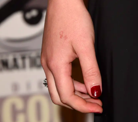 a closeup of her hand and a faint h20