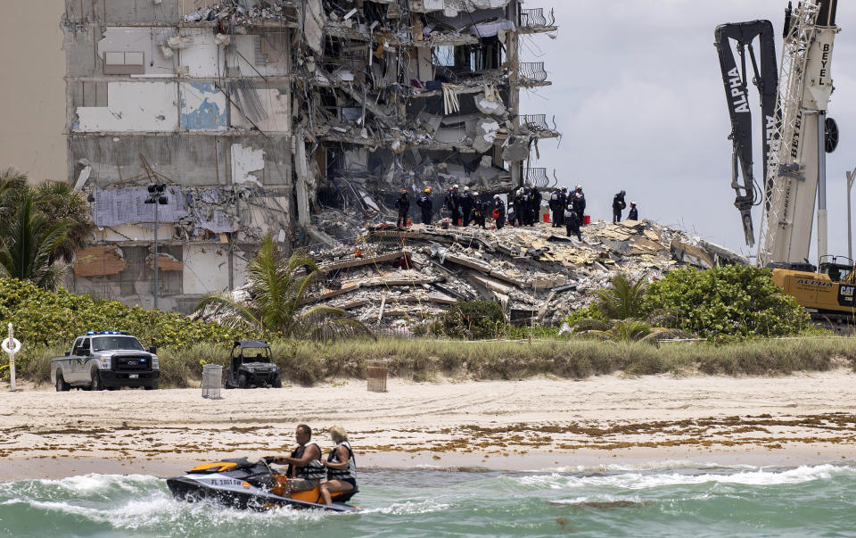 Image: The South Florida Urban Search and Rescue team look for survivors in the rubble of the partially collapsed Champlain Towers South condo building on June 26, 2021. (Joe Raedle / Getty Images file)