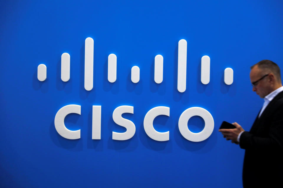 A visitor uses a mobile phone in front of the Cisco booth at the Mobile World Congress in Barcelona, Spain, February 26, 2019. REUTERS/Rafael Marchante