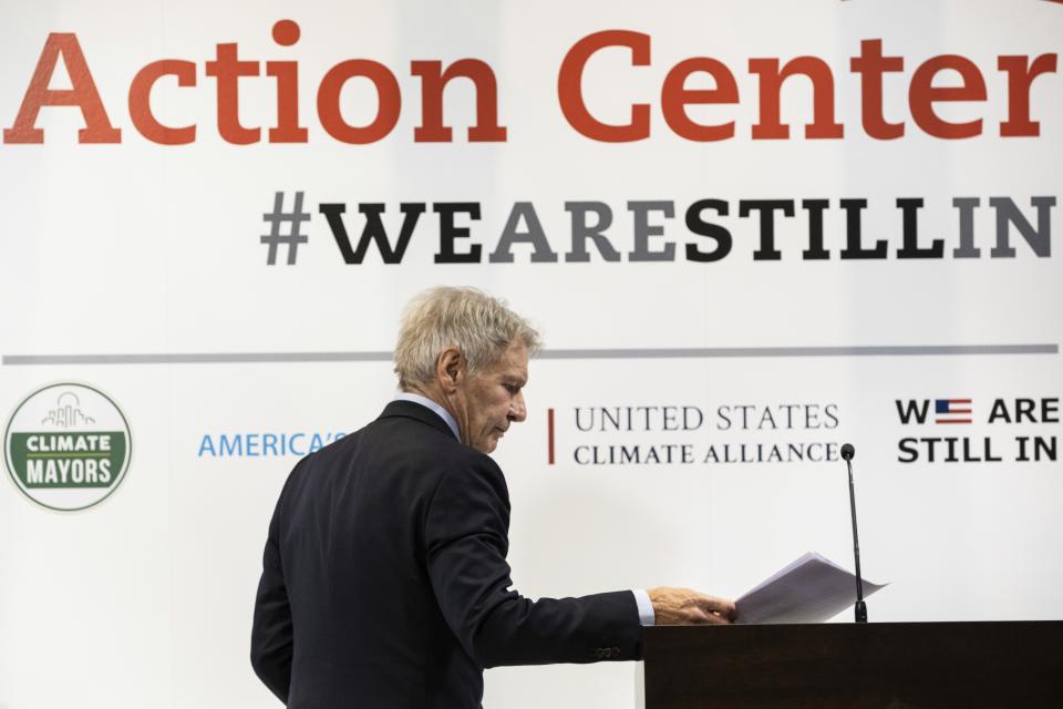 US actor Harrison Ford walks at the stage of the US Climate action center during the COP25 summit in Madrid, Tuesday Dec. 10, 2019. (AP Photo/Bernat Armangue)