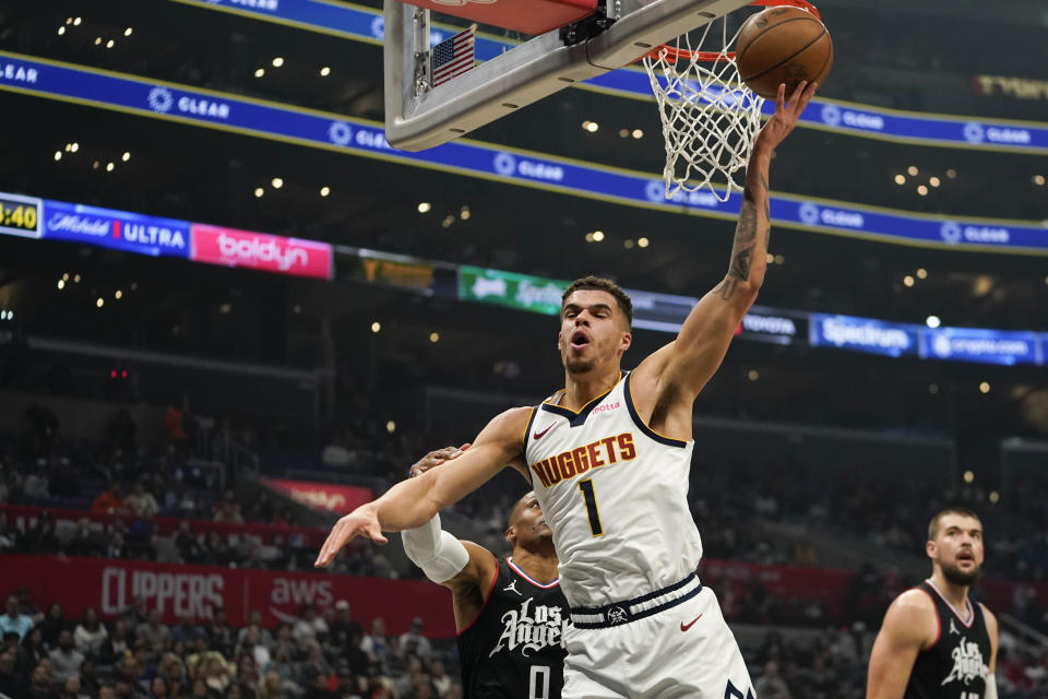 Denver Nuggets forward Michael Porter Jr. (1) reacts after being fouled by Los Angeles Clippers guard Russell Westbrook (0) during the first half of an NBA basketball game, Wednesday, Dec. 6, 2023, in Los Angeles. (AP Photo/Ryan Sun)