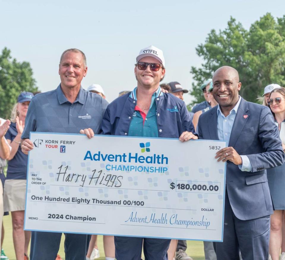 Gary Burnison, Korn Ferry CEO, left, and Mayor Quinton Lucas, right, present the check to Harry Higgs, who won the AdventHealth Championship on Sunday at Blue Hills Country Club.