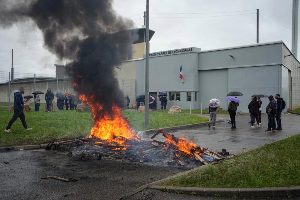 Prison workers protest outside the Corbas prison, Lyon, on Wednesday (AP)