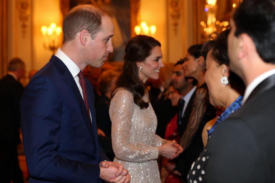 The Duke and Duchess of Cambridge speak to guests at the reception (PA)