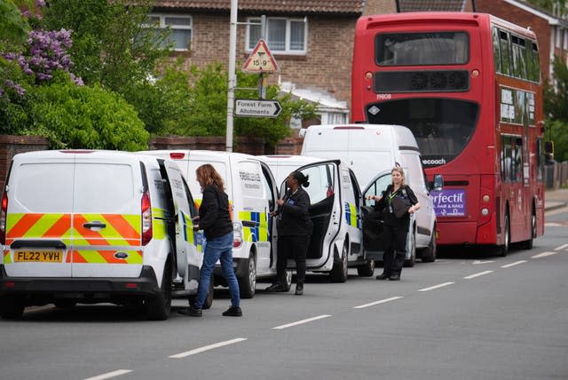 Police and forensic investigators in Hainault, north east London.