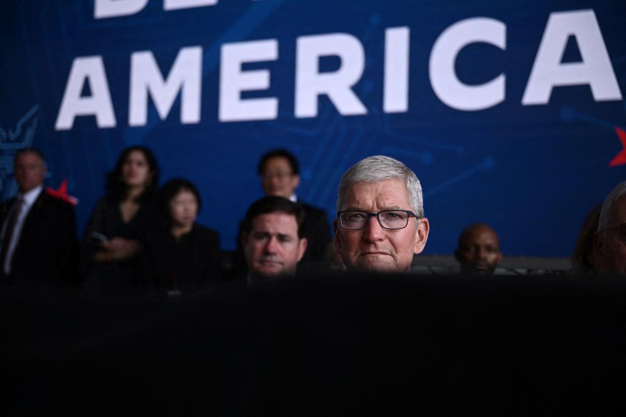 Apple CEO Tim Cook listens to US President Joe Biden deliver remarks on his economic plan at TSMC Semiconductor Manufacturing Facility in Phoenix, Arizona, on December 6, 2022. (Photo by Brendan SMIALOWSKI / AFP) (Photo by BRENDAN SMIALOWSKI/AFP via Getty Images)