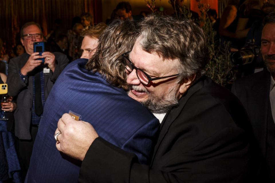 Two men hugging.