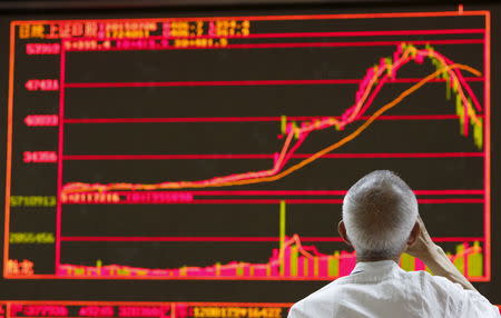 A man watches a board showing the graphs of stock prices at a brokerage office in Beijing, China, July 6, 2015. REUTERS/Kim Kyung-Hoon