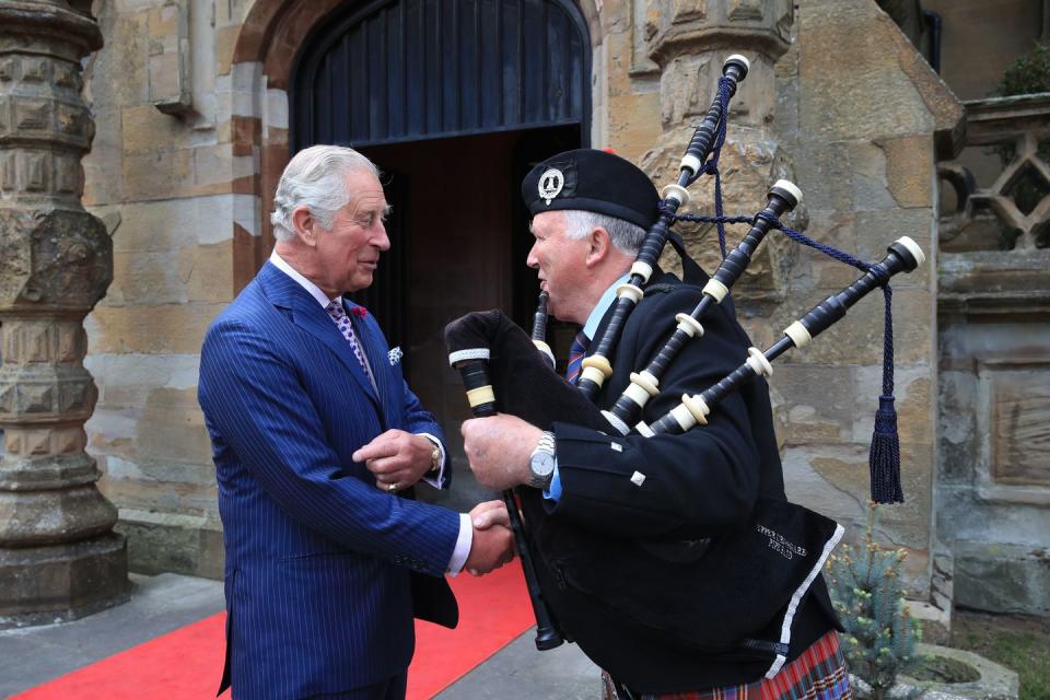 <p>Charles meets a bagpipe player at Brownlow House in Lurgan, Northern Ireland.</p>