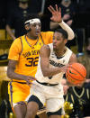 Colorado guard Keeshawn Barthelemy, front, looks to pass the ball as Arizona State forward Alonzo Gaffney defends during the first half of an NCAA college basketball game Thursday, Feb. 24, 2022, in Boulder, Colo. (AP Photo/David Zalubowski)