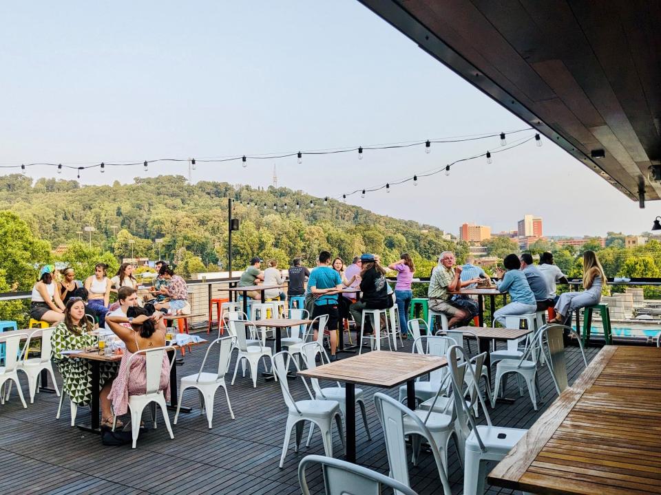 Guests hang out on the rooftop at Archetype Brewing and Kitchen during its soft opening weekend in June 2023. The taproom-restaurant is at 39 Banks Ave. on Asheville's South Slope.