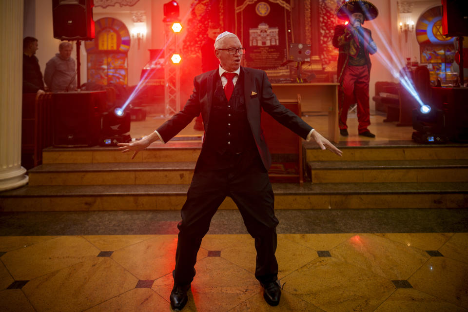 A member of the Ukrainian Jewish community shows off his dancing moves during Purim celebrations and a festive meal at the Great Choral Synagogue in Kyiv, Ukraine, Sunday, March 24, 2024. (AP Photo/Vadim Ghirda)