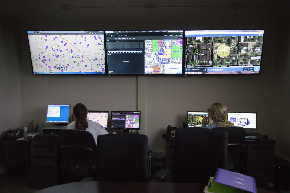 FILE - In this Wednesday, Feb. 8, 2017 file photo, members of the Chicago Police Department work with new predictive and tracking ShotSpotter technologies in a strategic decision support center at the Chicago Police Department's 11th district headquarters. In a Monday, May 3, 2021 court filing, community groups argued the gunshot detection system routinely reports gunshots where there are none, sending officers into predominantly Black and Latino neighborhoods for "unnecessary and hostile" encounters. (Erin Hooley/Chicago Tribune via AP, File)