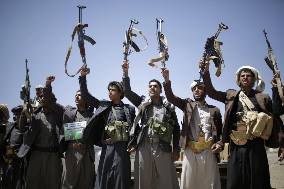 FILE - In this Sept. 21, 2019 file photo, Shiite Houthi tribesmen hold their weapons as they chant slogans during a tribal gathering showing support for the Houthi movement, in Sanaa, Yemen. Saudi Arabia and Yemen’s Iran-backed Houthi rebels are holding indirect, behind-the-scenes talks to end the impoverished Arab country’s devastating five-year war. Officials from both sides have told The Associated Press, Wednesday, Nov. 13, 2019, that the negotiations are taking place with Oman, which borders both Yemen and Saudi Arabia, as mediator. (AP Photo/Hani Mohammed, File)