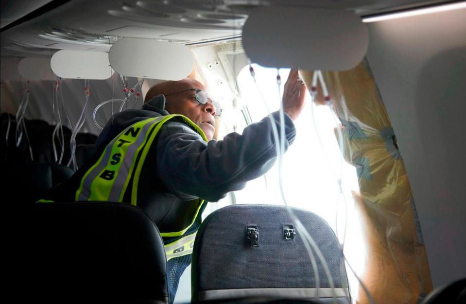 PHOTO: In this photo released by the National Transportation Safety Board, NTSB Investigator-in-Charge John Lovell examines the fuselage plug area of Alaska Airlines Flight 1282 on Sunday, Jan. 7, 2024, in Portland, Ore. (National Transportation Safety Board via AP)