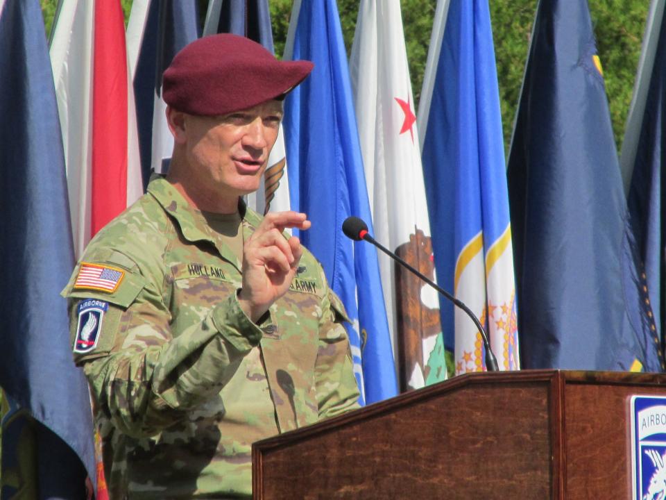 Command Sgt. Maj. T.J. Holland, the outgoing senior enlisted leader for the 18th Airborne Corps, makes remarks during a change of responsibility ceremony Friday, Aug. 11, 2023, on Fort Liberty.