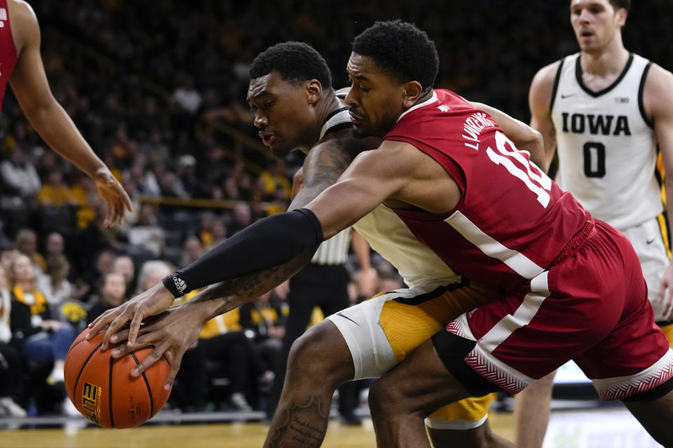 Nebraska guard Jamarques Lawrence (10) fights for a loose ball with Iowa guard Tony Perkins, left, during the second half of an NCAA college basketball game, Sunday, March 5, 2023, in Iowa City, Iowa. Nebraska won 81-77. (AP Photo/Charlie Neibergall)