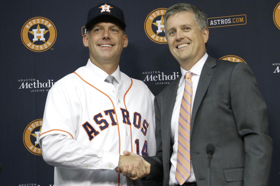 FILE - In this Sept. 29, 2014, file photo, Houston Astros general manager Jeff Luhnow, right, and A.J. Hinch pose after Hinch is introduced as the new manager of the baseball club in Houston. Hinch and Luhnow were fired Monday, Jan. 13, 2020, after being suspended for their roles in the team's extensive sign-stealing scheme from 2017. (AP Photo/Pat Sullivan, File)