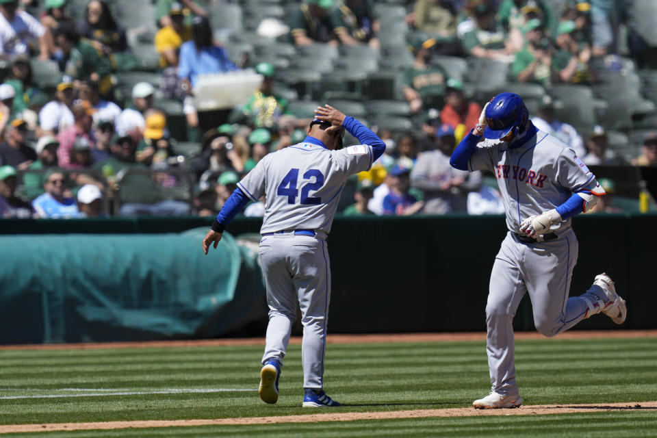 New York Mets' Pete Alonso, right, celebrates with infield & third base coach Joey Cora after hitting a solo home run against the Oakland Athletics during the fourth inning of a baseball game in Oakland, Calif., Saturday, April 15, 2023. (AP Photo/Godofredo A. Vásquez)