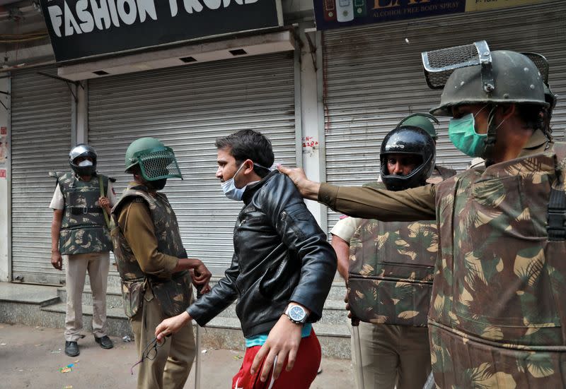 Police detain a youth as he argues with them after they cleared the site of the longest-running protest against a new citizenship law following the lockdown by Delhi state government, in New Delhi