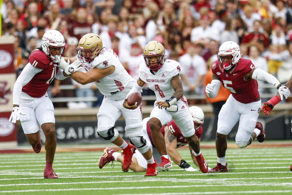 Boston College Eagles quarterback Thomas Castellanos (1) carries the ball while evading Florida State Seminoles defensive lineman Jared Verse (5) during the first half of an NCAA football game on Saturday, Sept. 16, 2023, in Chestnut Hill, Mass. (AP Photo/Greg M. Cooper)