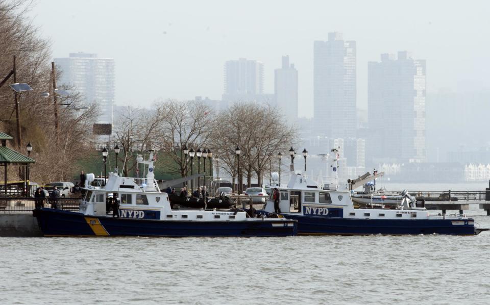Police divers found the bodies of two people in the Hudson River near Sinatra Park after a search by units from New York City and New Jersey began, Sunday, April 13, 2014, in Hoboken, N.J. (AP Photo/Joe Epstein)