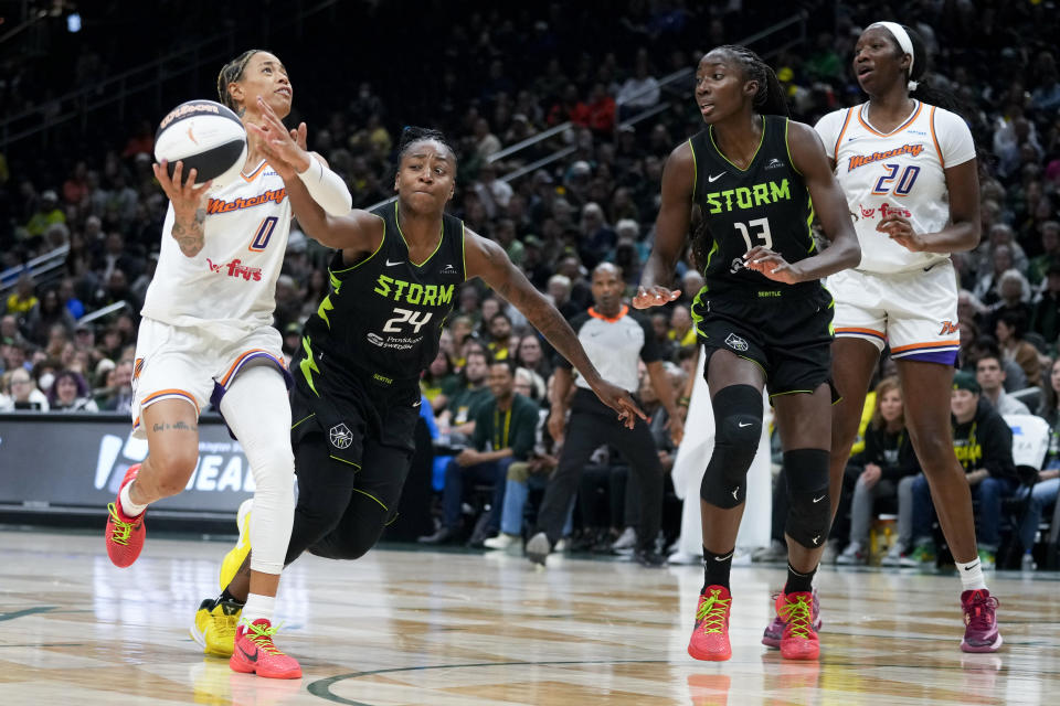 Phoenix Mercury guard Natasha Cloud drives to the basket against Seattle Storm guard Jewell Loyd (24) as center Ezi Magbegor (13) and Mercury forward Liz Dixon (20) watch during the second half of a WNBA basketball game Tuesday, June 4, 2024, in Seattle. The Storm won 80-62. (AP Photo/Lindsey Wasson)