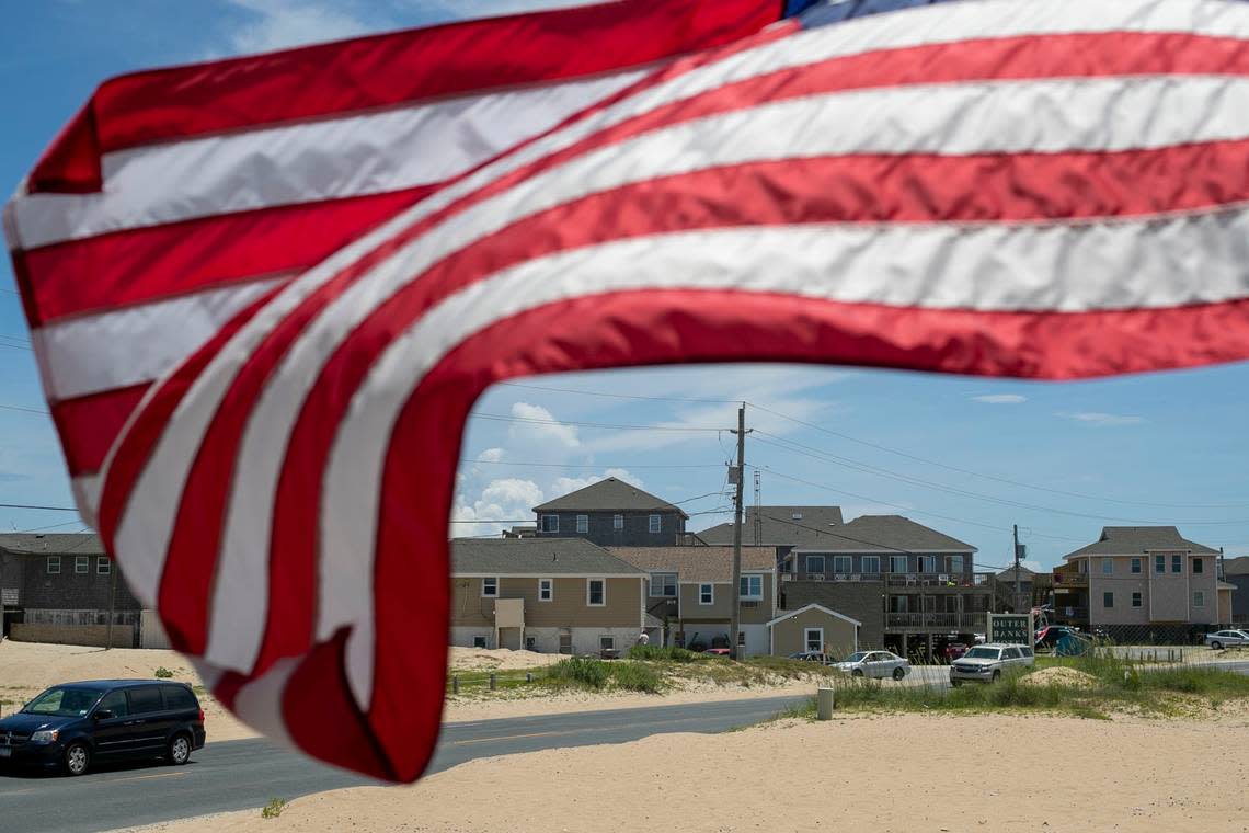 The American Flag is whipped by the wind along NC 12 at the Cape Hatteras Motel on Thursday, July 1, 2021 in Buxton, N.C. Robert Willett/rwillett@newsobserver.com