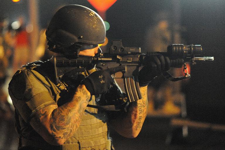 A law enforcement officer watches on during a protest on West Florissant Avenue in Ferguson, Missouri on August 18, 2014