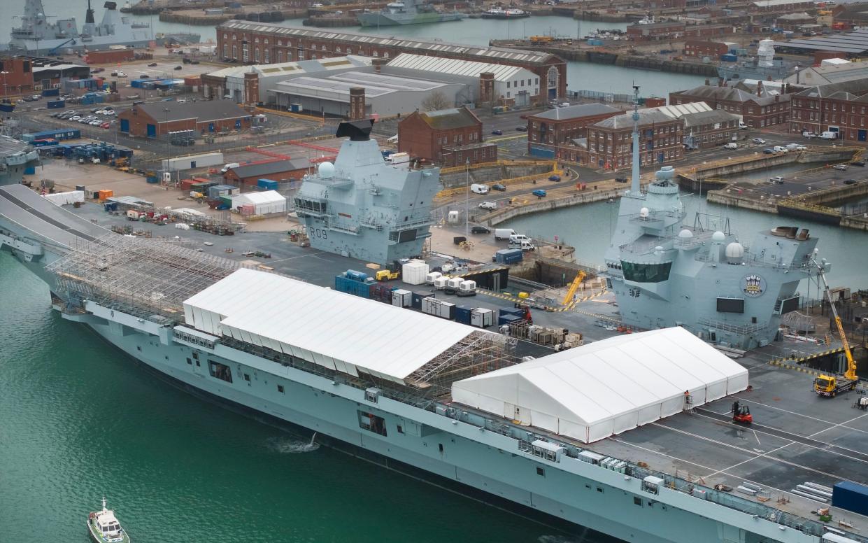 Work is carried out on the flight deck of Royal Navy aircraft carrier HMS Prince of Wales at Portsmouth in Hampshire