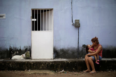 Gabriela Alves de Azevedo, 22, holds her two-year-old daughter Ana Sophia, who was born with microcephaly, at their house in Olinda, Brazil, August 7, 2018. Gabriela had planned to finish high school and study physical therapy. Now, she spends her days caring for her child. Her husband left shortly after Ana Sophia's birth. He could not accept their child's condition, Gabriela says, and does not pay child support. "I went into depression and my family helped me," she said. "If it was not for them, I would have gone crazy." REUTERS/Ueslei Marcelino/Files