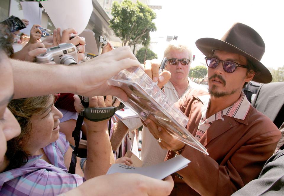 Johnny Depp signing autographs