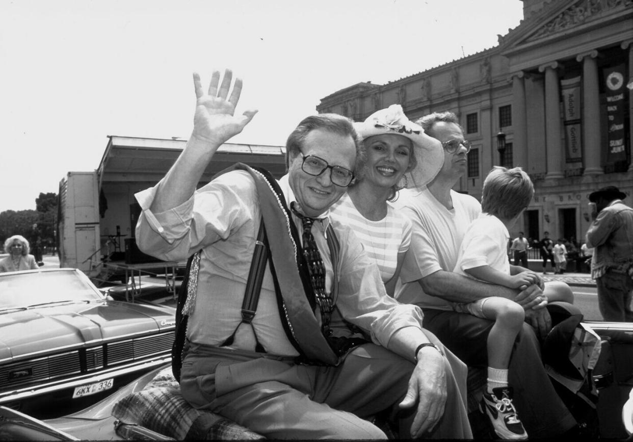 Larry King waves outside of the Brooklyn Museum near Prospect Park. He was born in the borough in 1933.