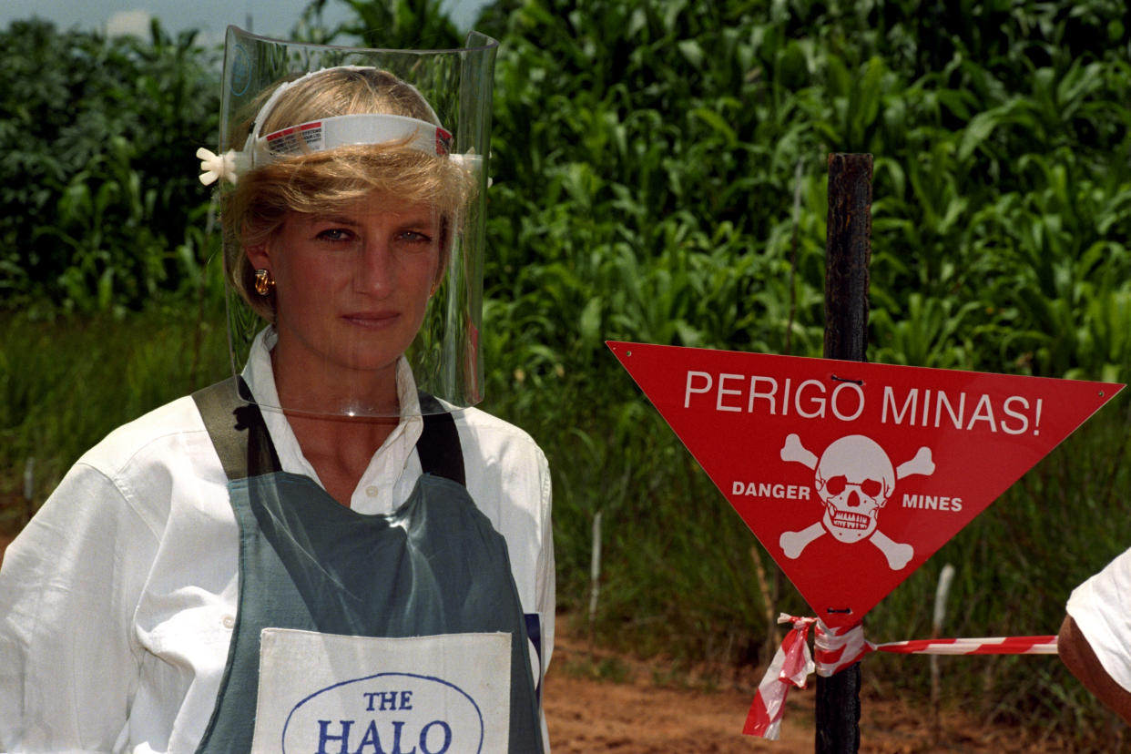 PA NEWS : 15/1/97 : DIANA, PRINCESS OF WALES, WEARS A PROTECTIVE MASK AND JACKET AS SHE STANDS NEXT TO A WARNING SIGN ON THE EDGE OF A MINEFIELD IN ANGOLA, DURING HER VISIT TO SEE THE WORK OF THE BRITISH RED CROSS. (PHOTO BY JOHN STILLWELL ). Clare Short, struck a similar pose when she stood in the midst of a mock-up mine field on Brighton Beach as part of the Government's heightened campaign to ban landmines which was announced during the Labour Party Conference. See PA story LABOUR Landmines.   The International Campaign to Ban Landmines, which came to prominence following the Princess's death, and campaign coordinator Jody Williams were awarded the Nobel Peace prize on 10/10/97. See PA story NOBEL Mines.   Photo by John Stillwell/PA  The Diana, Princess of Wales Memorial Fund, called on the US and British governments to halt the use of cluster bombing in Afghanistan. The fund's chief executive, Andrew Purkis, warned that the weapons, recently deployed against Taliban forces on the front line with the Northern Alliance, represented a serious long-term threat to civilians, similar to that posed by landmines.   (Photo by John Stillwell - PA Images/PA Images via Getty Images)