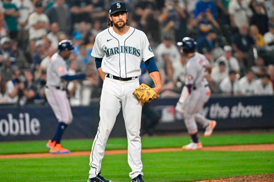 Seattle Mariners relief pitcher Penn Murfee (56) looks away as Houston Astros shortstop Jeremy Pena (3) rounds third base after hitting a solo home run in the 18th inning of game 3 of the ALDS on Saturday, Oct. 15, 2022, at T-Mobile Park in Seattle.