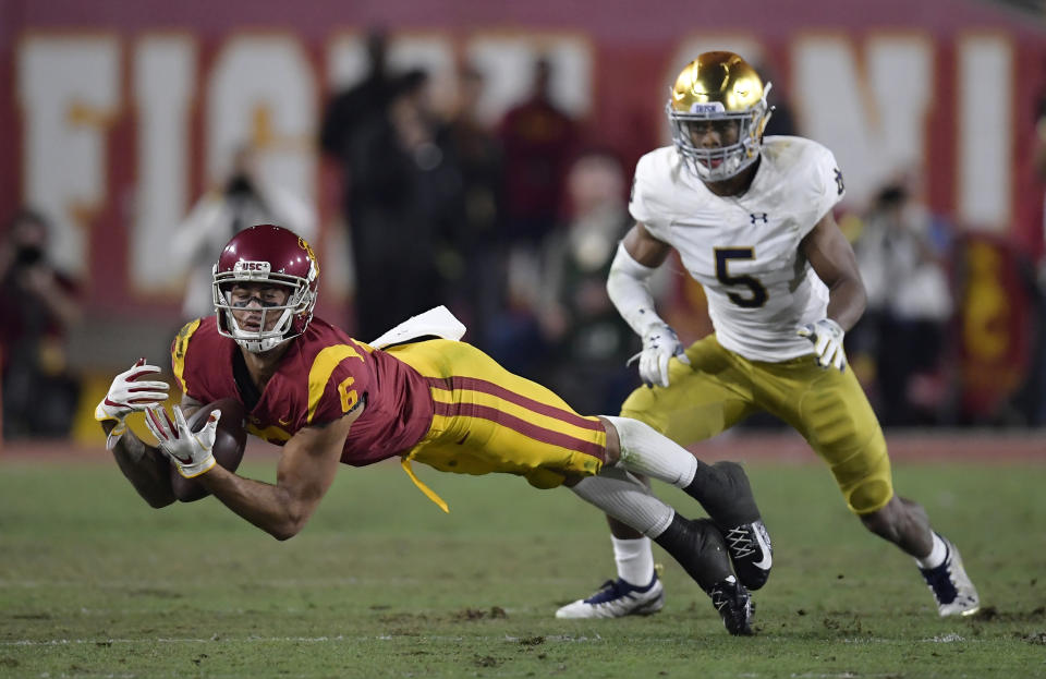 Southern California wide receiver Michael Pittman Jr., left, attempts to catch a pass while under pressure from Notre Dame cornerback Troy Pride Jr. during the first half of an NCAA college football game Saturday, Nov. 24, 2018, in Los Angeles. The play was initially ruled a catch but the call was overturned after review. (AP Photo/Mark J. Terrill)