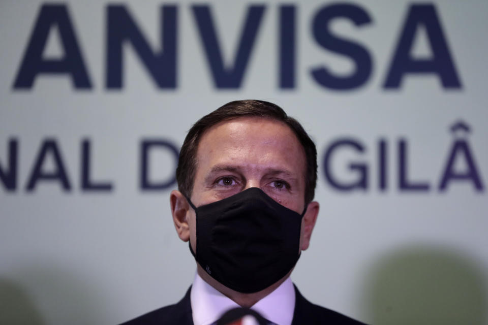 Sao Paulo Gov. Joao Doria speaks during a press conference after a meeting on the CoronaVac vaccine, at the National Health Surveillance Agency headquarters in Brasilia, Brazil, Wednesday, Oct. 21, 2020. Brazil’s President Jair Bolsonaro rejected on Wednesday the announced purchase of 46 million doses of the potential vaccine being developed by a Chinese company and tested in Sao Paulo, a state governed by his political rival, prompting concern he was allowing politics to steer public health decisions. (AP Photo/Eraldo Peres)