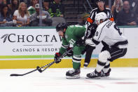 Dallas Stars center Tyler Seguin (91) and Los Angeles Kings defenseman Drew Doughty (8) battle for the puck during the first period of an NHL hockey game Friday, Oct. 22, 2021, in Dallas. (AP Photo/Richard W. Rodriguez)