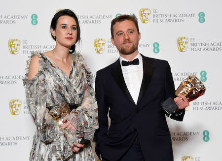 Lauren Dark and Michael Pearce hold their awards for Outstanding Debut by a British Writer Director or Producer at the British Academy of Film and Television Awards (BAFTA) at the Royal Albert Hall in London, Britain, February 10, 2019. REUTERS/Toby Melville