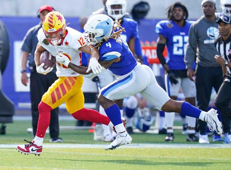 Apr 17, 2022; Birmingham, AL, USA; New Orleans Breakers defensive back Manny Patterson (4) grabs Philadelphia Stars wide receiver Chris Rowland (12) from behind at Protective Stadium. Mandatory Credit: Marvin Gentry-USA TODAY Sports