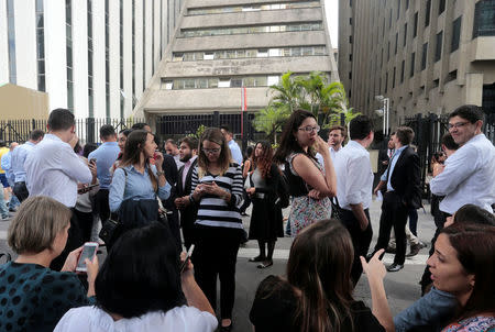 People are gather front of an evacuated building, after an earthquake that hit Bolivia, at Paulista avenue in Sao Paulo, Brazil April 2, 2018. The tremor was also felt in Brasilia and Sao Paulo. REUTERS/Leonardo Benassatto