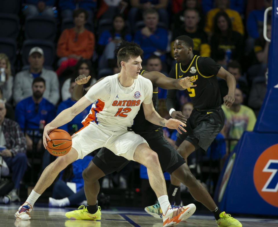Florida forward Colin Castleton (12) drives against Missouri guard Kobe Brown during the first half of an NCAA college basketball game Saturday, Jan. 14, 2023, in Gainesville, Fla. (AP Photo/Alan Youngblood)