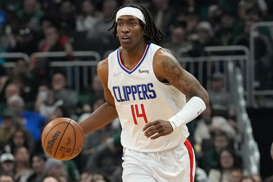 Terance Mann #14 of the LA Clippers dribbles the ball against the Milwaukee Bucks during the first half at Fiserv Forum on April 01, 2022 in Milwaukee, Wisconsin.