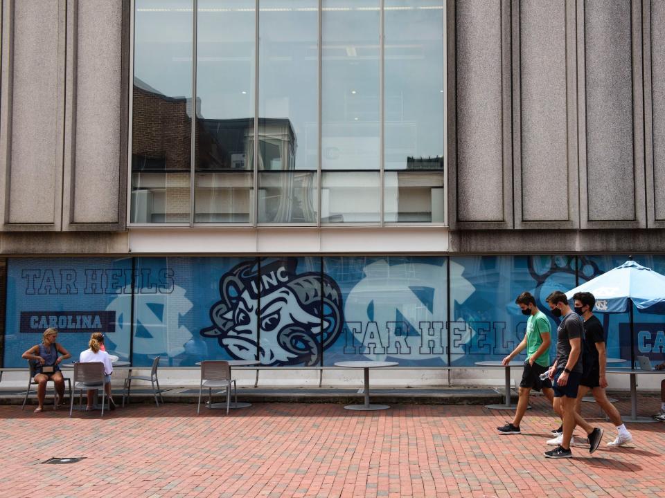 Students walk through the campus of the University of North Carolina at Chapel Hill on August 18, 2020 in Chapel Hill, North Carolina.