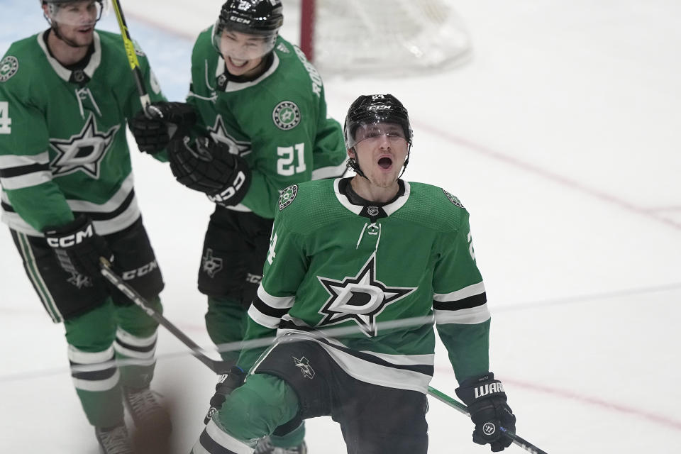 Dallas Stars center Roope Hintz, right, celebrates scoring an overtime goal in front of teammates Miro Heiskanen (4) Jason Robertson (21), ending an NHL hockey game against the Chicago Blackhawks in Dallas, Friday, Dec. 29, 2023. (AP Photo/LM Otero)