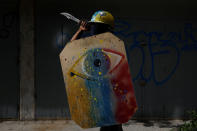 <p>A demonstrator holding a rudimentary shield and a knife poses for a picture before a rally against Venezuelan President Nicolas Maduro’s government in Caracas, Venezuela, May 27, 2017. He said: “I protest because the situation is very tough and we are going hungry. We really need a change.” (Photo: Carlos Garcia Rawlins/Reuters) </p>