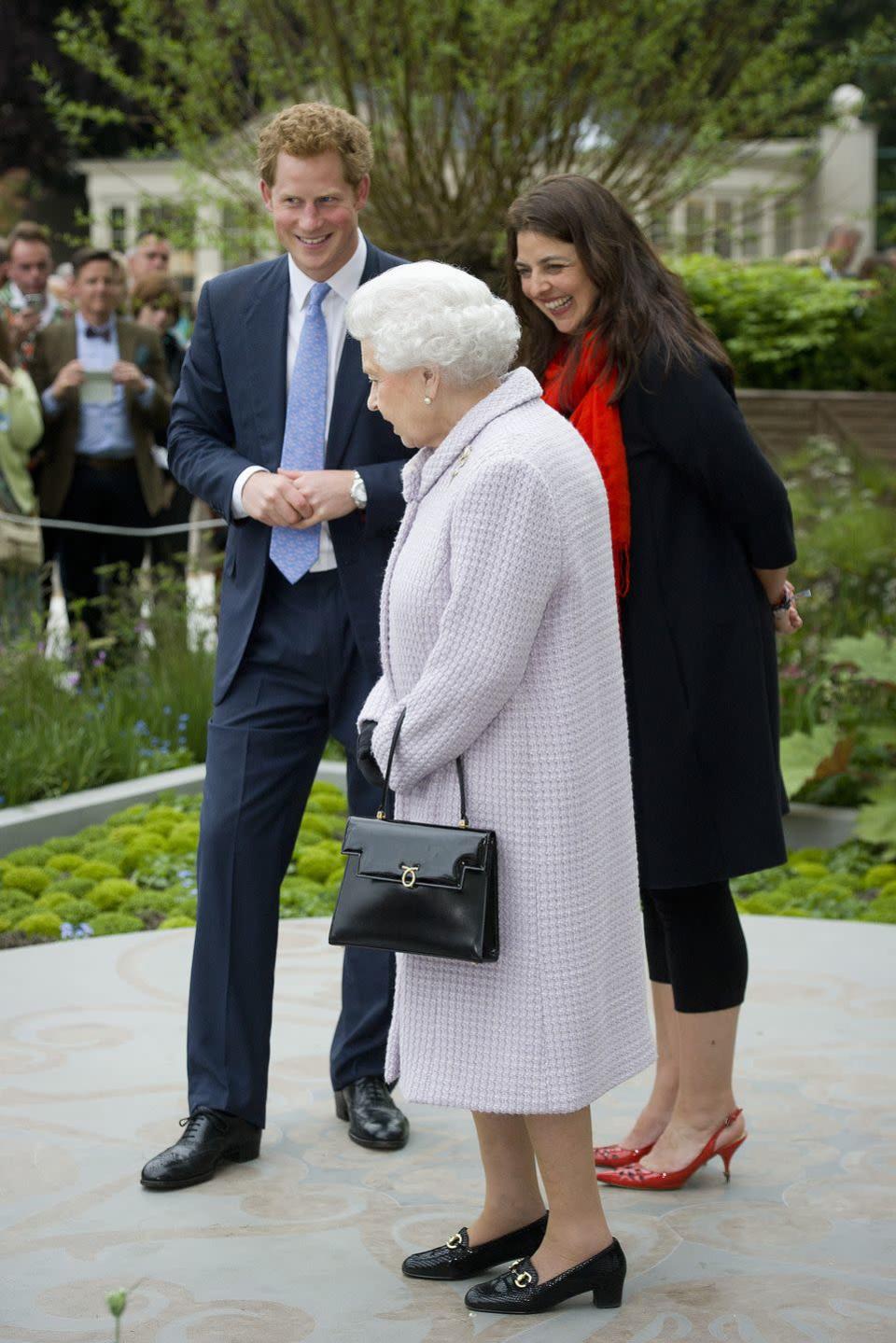 <p>Harry gives his grandmother a tour of the Sentebale Forget-Me-Not Garden at the 2013 show.</p>