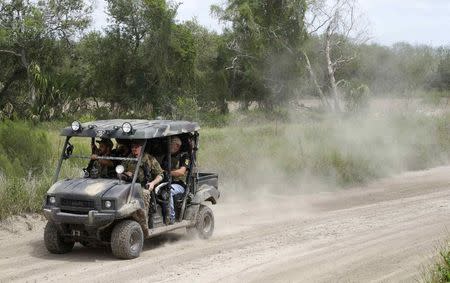 Members of the "Patriots" patrol the area in their UTV near the U.S.-Mexico border outside Brownsville, Texas September 2, 2014. REUTERS/Rick Wilking