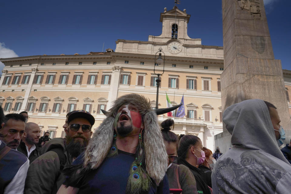 Demonstrators gather outside the lower Chamber during a protest by Restaurant and shop owners in Rome, Tuesday, April 6, 2021. Demonstrators demanded to reopen their business and protested against restrictive measures by the Italian Government to cope with the surge of COVID-19 cases. (AP Photo/Andrew Medichini)